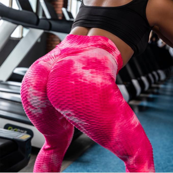 La vente en gros teignent en nouant le contrôle de ventre de pantalon de yoga les guêtres qu'extensibles de séance d'entraînement ont donné au yoga une consistance rugueuse Legging pour des femmes