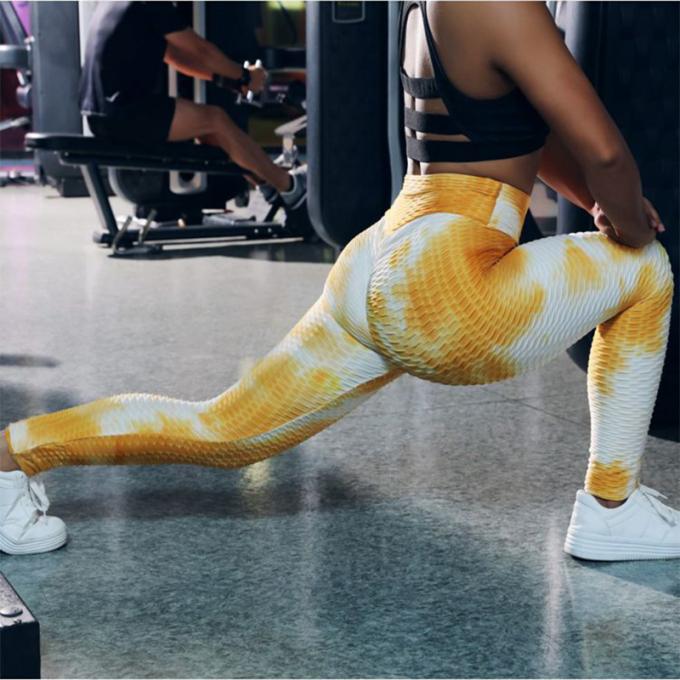 La vente en gros teignent en nouant le contrôle de ventre de pantalon de yoga les guêtres qu'extensibles de séance d'entraînement ont donné au yoga une consistance rugueuse Legging pour des femmes