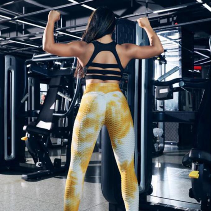 La vente en gros teignent en nouant le contrôle de ventre de pantalon de yoga les guêtres qu'extensibles de séance d'entraînement ont donné au yoga une consistance rugueuse Legging pour des femmes