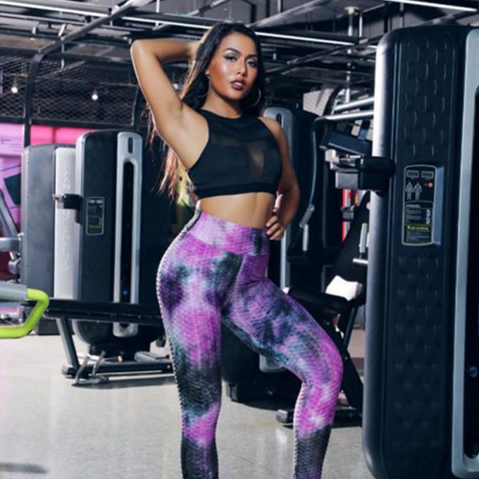 La vente en gros teignent en nouant le contrôle de ventre de pantalon de yoga les guêtres qu'extensibles de séance d'entraînement ont donné au yoga une consistance rugueuse Legging pour des femmes
